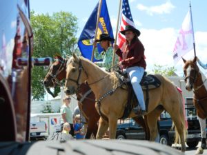 East Helena Valley Rodeo Parade, riders with flags atop their horses.